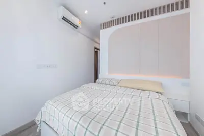 Modern minimalist bedroom with stylish decor and air conditioning unit