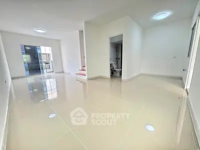 Spacious modern living area with glossy tiled floors and natural light