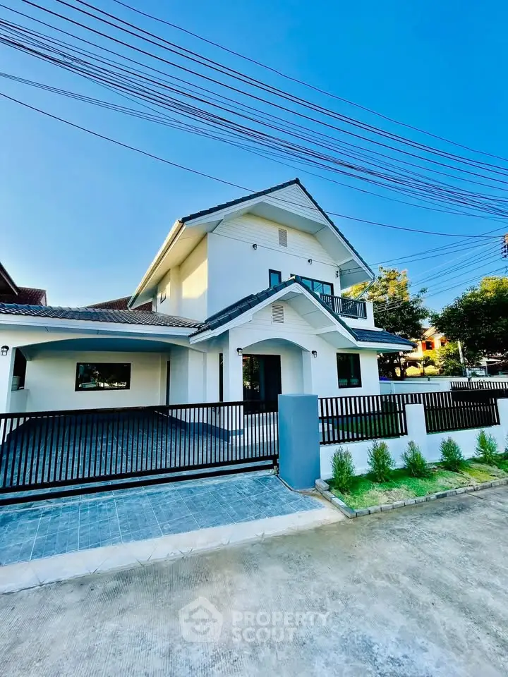 Stunning modern two-story house with sleek design and spacious driveway, perfect for family living.