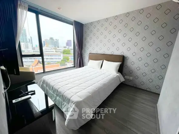 Modern bedroom with city view and stylish wallpaper in high-rise apartment