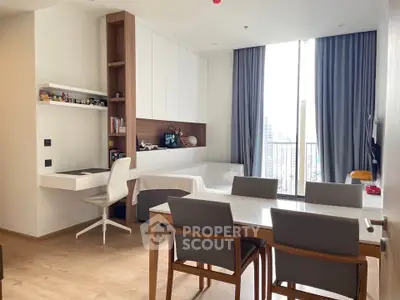 Modern living room with dining area and study desk, featuring floor-to-ceiling windows and city view.