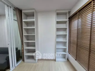 Modern living room with built-in shelves and large window blinds