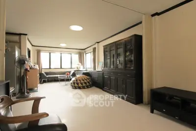 Spacious living room with elegant furniture and large windows offering natural light.