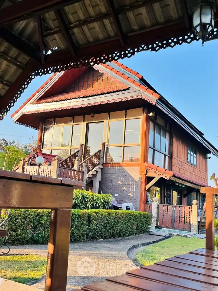 Charming traditional wooden house with lush garden and elegant architecture.