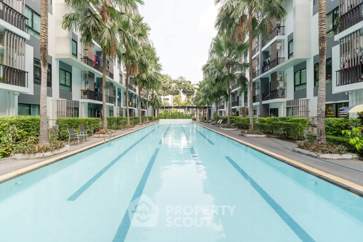 Luxurious apartment complex with a stunning outdoor pool and lush greenery, perfect for relaxation and leisure.
