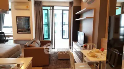 Modern studio apartment with open layout, featuring cozy living area and stylish kitchen.