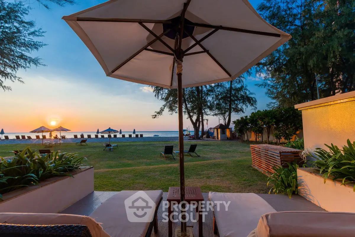 Stunning beachfront property with sunset view and lush garden, perfect for relaxation and luxury living.
