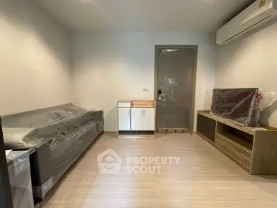 Modern living room with air conditioning and sleek wooden flooring