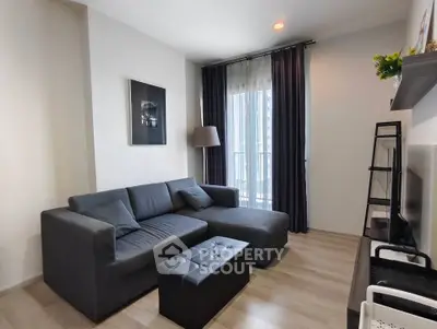 Modern living room with stylish gray sofa and floor-to-ceiling window