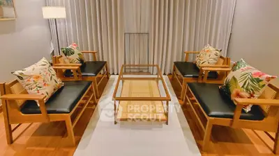 Stylish living room with wooden furniture and floral cushions, perfect for cozy gatherings.