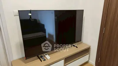 Modern living room with sleek TV and wooden cabinet