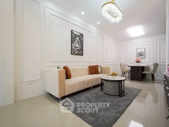 Elegant living room with modern decor and plush seating in a stylish apartment.