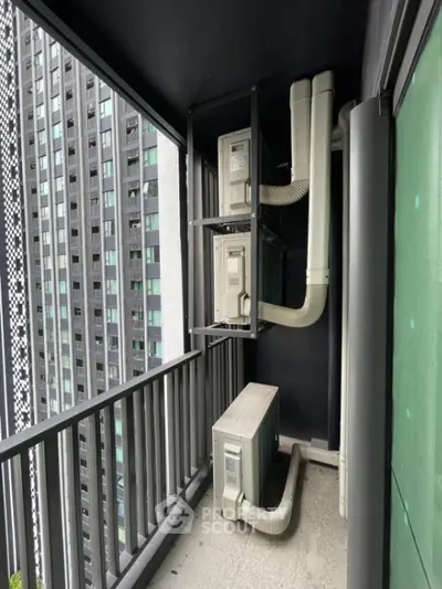 Modern apartment balcony with air conditioning units and city view