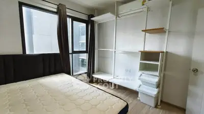 Modern bedroom with large window and minimalist storage solutions