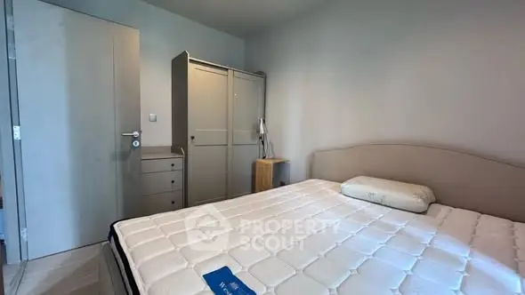 Cozy bedroom with modern furniture and comfortable bed in a minimalist design.