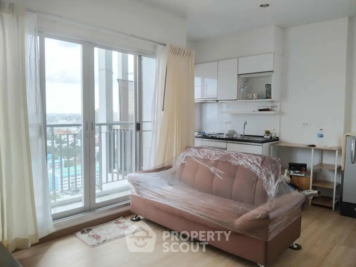 Modern apartment interior with balcony view and compact kitchen