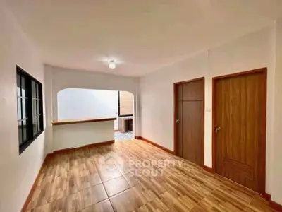 Spacious open-plan living area with wooden flooring and modern design