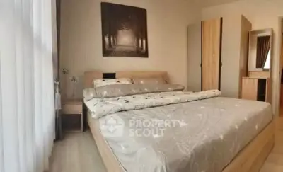 Cozy bedroom with modern decor and large bed in a stylish apartment.