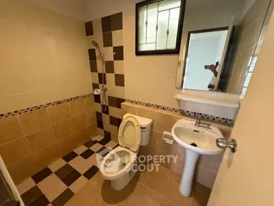 Cozy bathroom with modern fixtures and stylish tile design, perfect for a comfortable living experience.