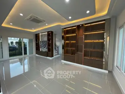 Spacious modern living room with elegant lighting and built-in shelving