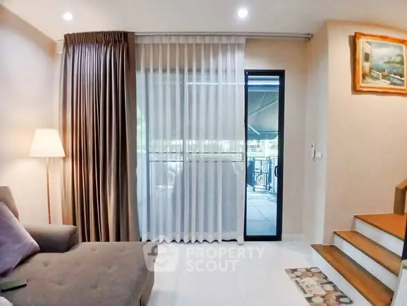 Cozy living room with modern decor and balcony access