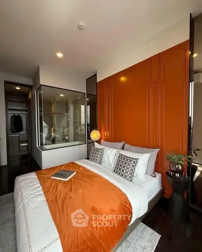 Luxurious modern bedroom with orange accent wall and stylish decor