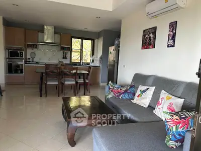 Spacious living room with modern kitchen, featuring stylish decor and comfortable seating in a cozy open layout.