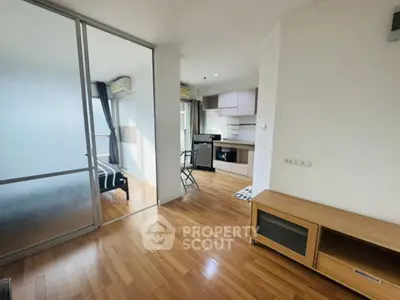 Modern apartment interior with wooden flooring and open kitchen layout