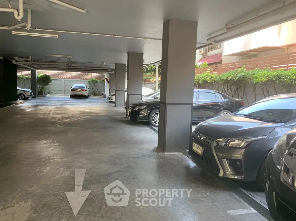 Spacious covered parking area with multiple cars in a residential building