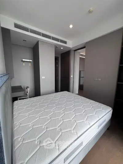 Modern bedroom with stylish decor and comfortable mattress in a contemporary apartment.