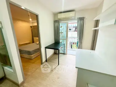 Modern apartment interior with bedroom and balcony view, featuring sleek design and natural light.