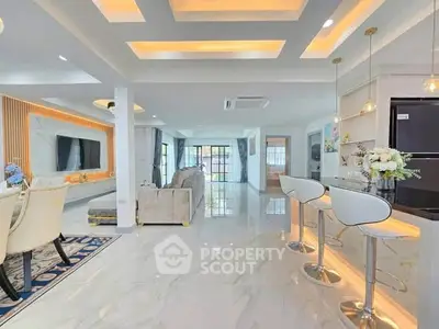 Luxurious open-plan living room with modern kitchen and elegant decor