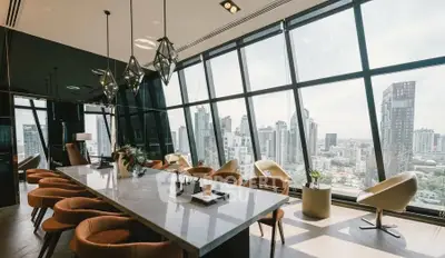 Luxurious modern living room with panoramic city view and elegant furnishings.