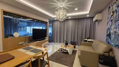 Modern living room with stylish decor, featuring a cozy sofa, elegant lighting, and a sleek entertainment setup.