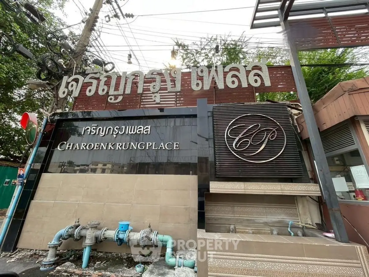 Entrance of Charoenkrung Place with signage and exterior view.