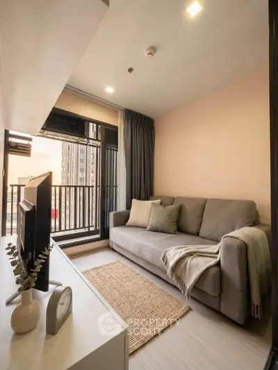 Cozy living room with modern decor and balcony view in urban apartment