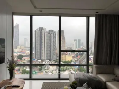 Luxurious living room with stunning city view from high-rise apartment window.