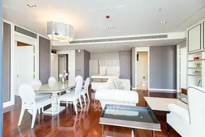 Luxurious open-plan living and dining area with elegant furnishings and hardwood floors.