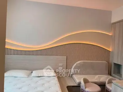 Modern bedroom with stylish wave lighting and cozy seating area