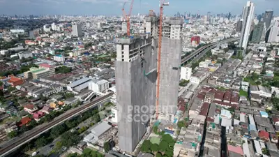Aerial view of high-rise building under construction in bustling cityscape
