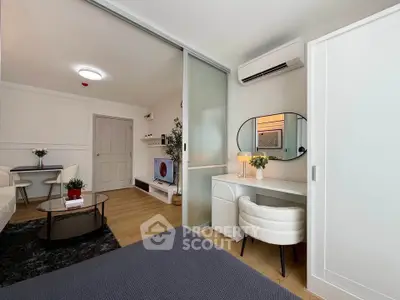 Modern living room with stylish furniture and air conditioning, featuring a cozy workspace and sleek decor.