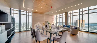 Luxurious high-rise living room with panoramic city views and modern furnishings.