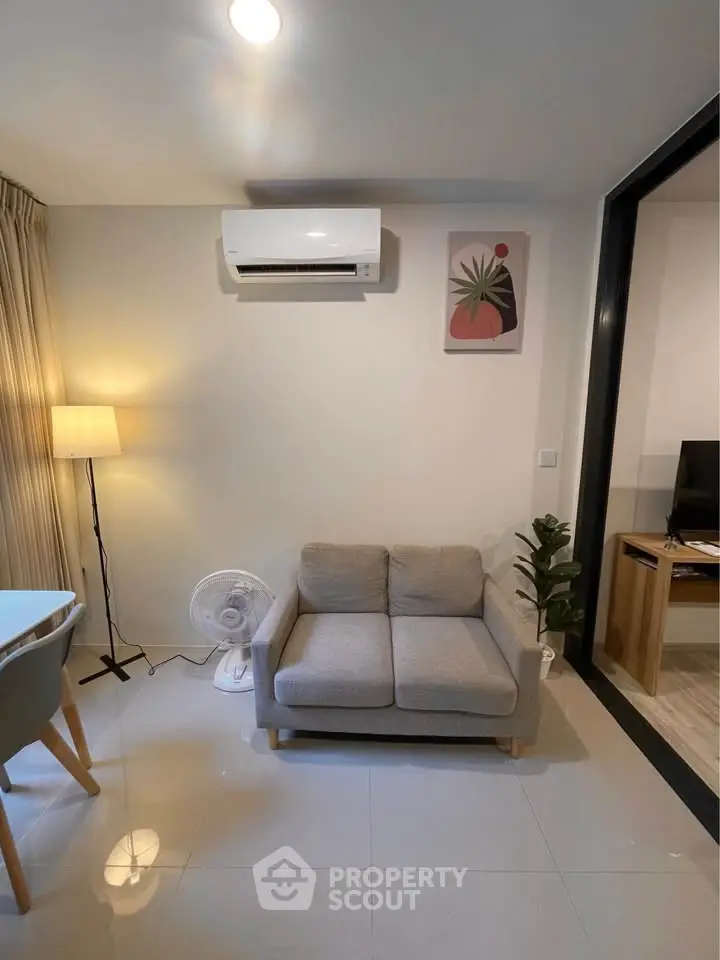 Modern living room with air conditioning, cozy sofa, and stylish decor in a contemporary apartment.
