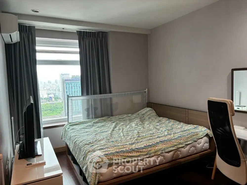 Modern bedroom with city view, featuring cozy bed and stylish furniture.