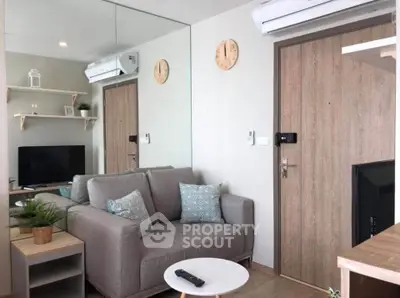 Modern living room with cozy sofa and wall-mounted TV in stylish apartment.