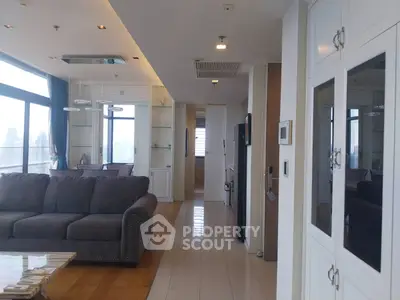 Spacious modern living room with large windows and elegant furnishings