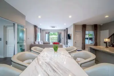 Spacious modern living room with open layout and elegant marble dining table.