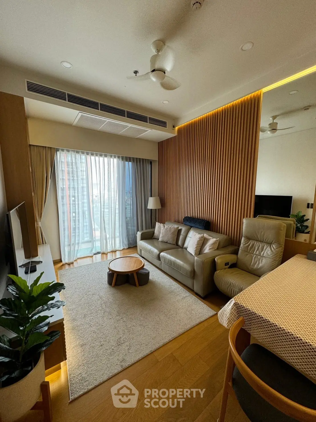 Modern living room with stylish decor and large window offering natural light
