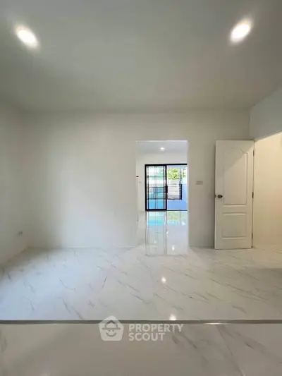 Spacious modern interior with glossy white flooring and open layout, perfect for contemporary living.