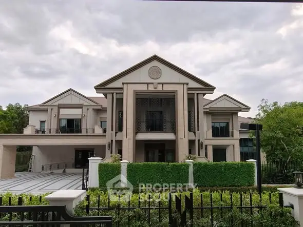 Luxurious mansion with grand entrance and lush greenery, perfect for upscale living.